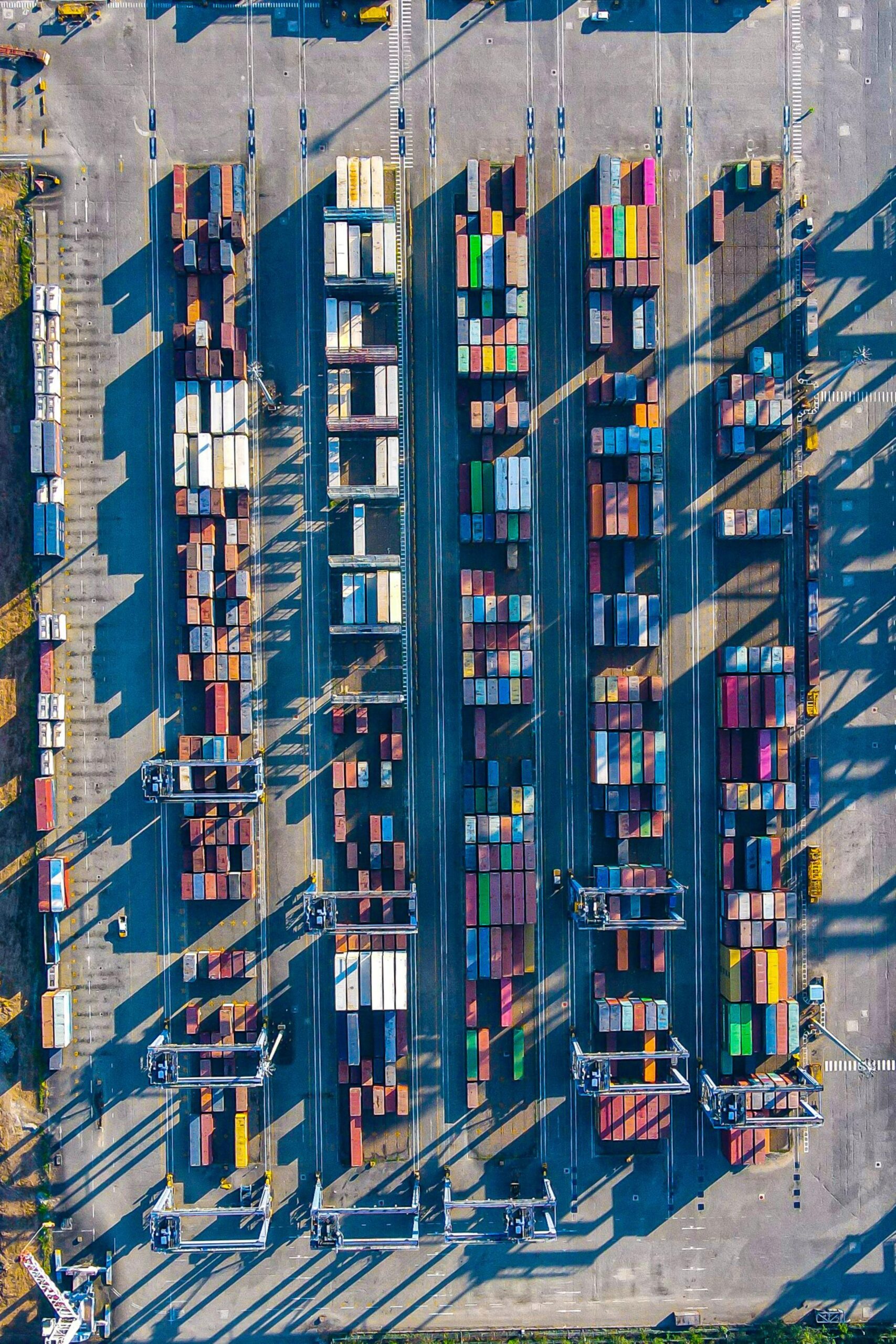 Rows of shipping containers at a port, seen from above